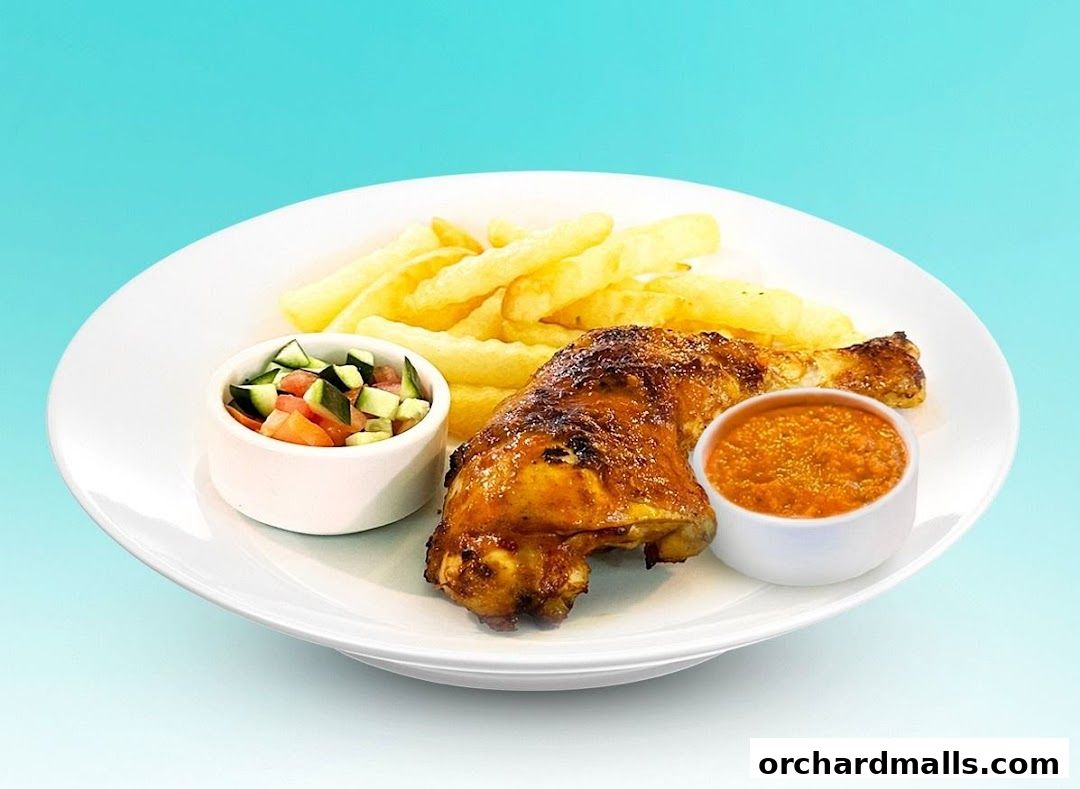 A plate of grilled chicken with fries, salad, and sauce against a blue background.