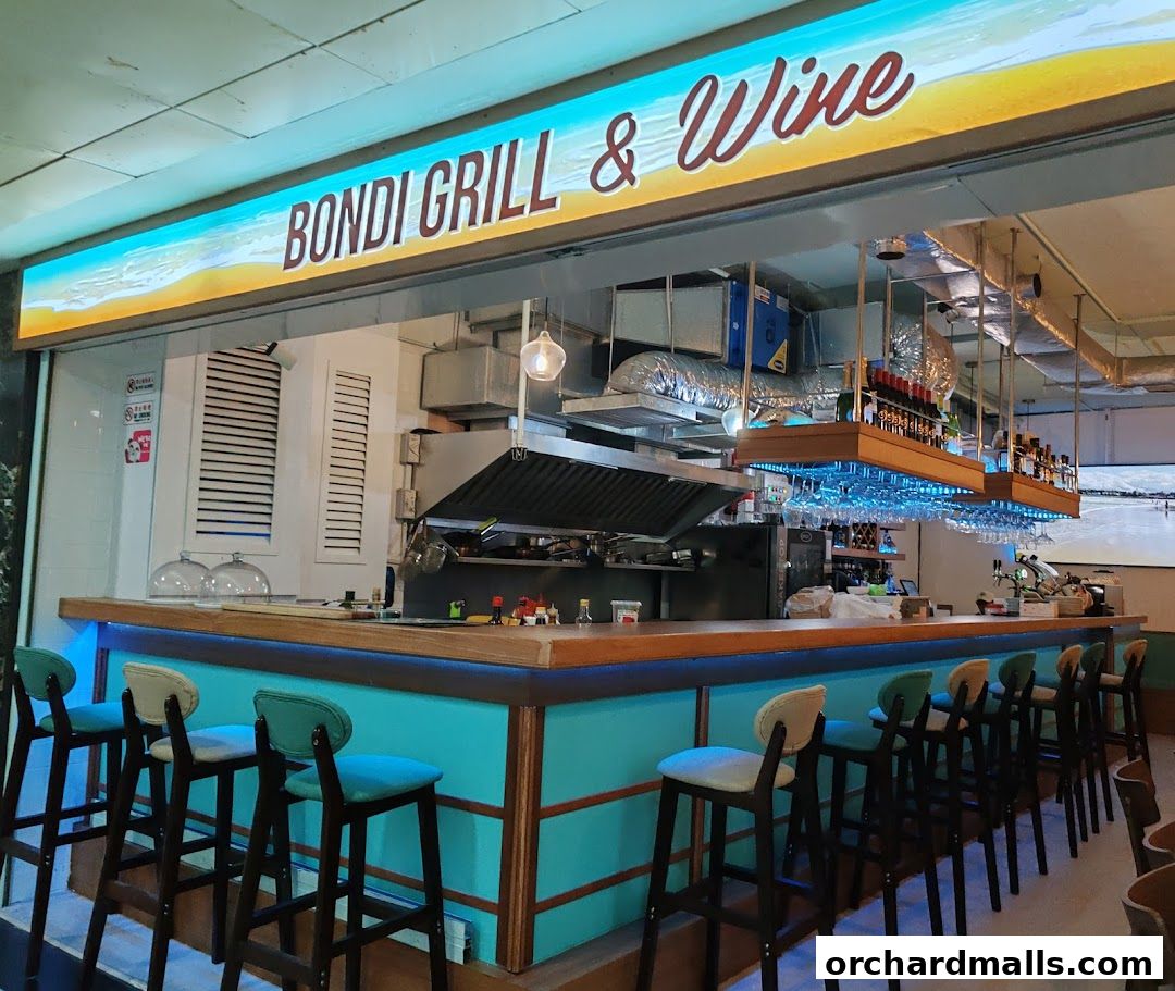 Interior view of Bondi Grill & Wine bar with a counter, stools, and bottles of wine.