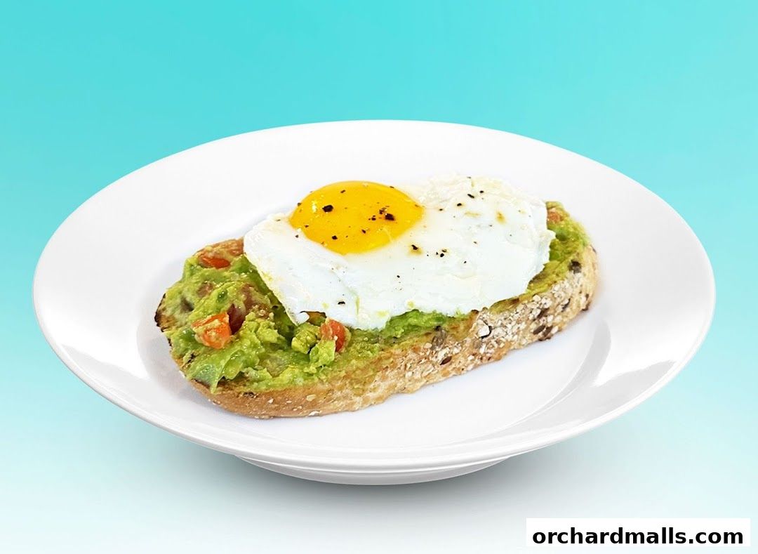 A slice of whole-grain toast topped with mashed avocado and a fried egg.