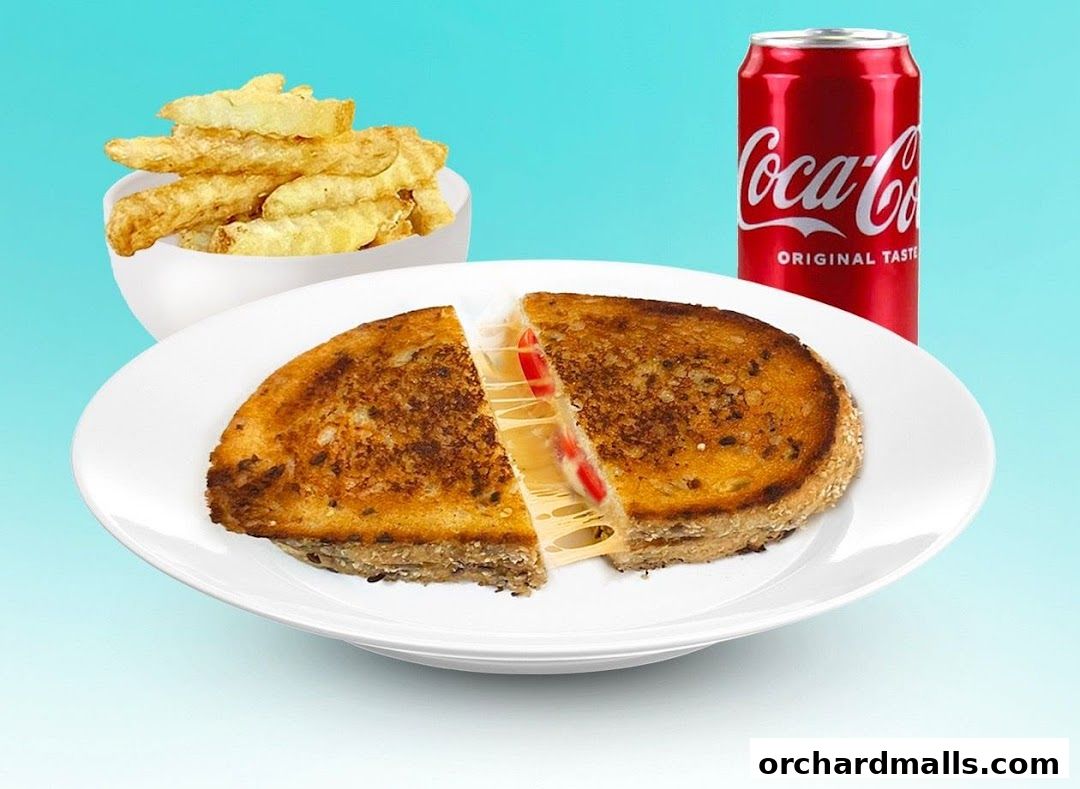 A grilled cheese sandwich with fries and a can of Coca-Cola.