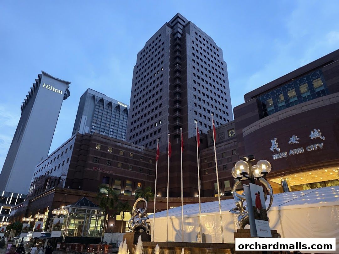 Ngee Ann City complex with Hilton hotels and a fountain in the foreground.