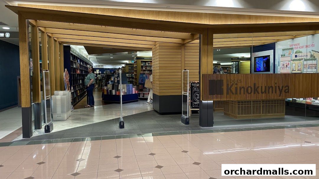 The entrance to Books Kinokuniya Singapore Main Store, showcasing its wooden facade and interior bookshelves.