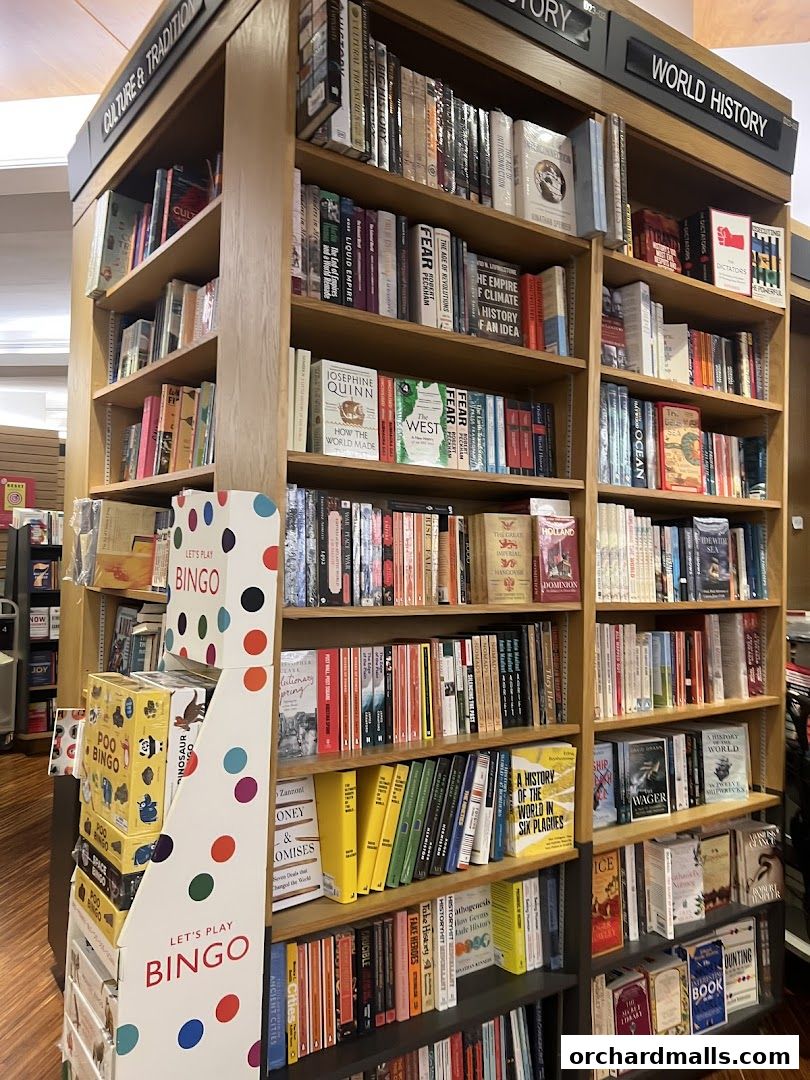 A wide selection of books displayed on shelves in a bookstore, with a 'Let's Play Bingo' display.