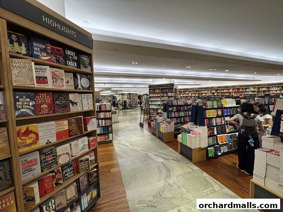 Interior view of a large bookstore with shelves full of books and customers browsing.