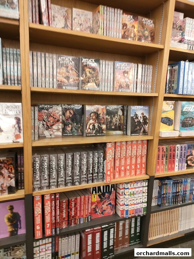Shelves filled with manga books, including Attack on Titan and Vinland Saga series.