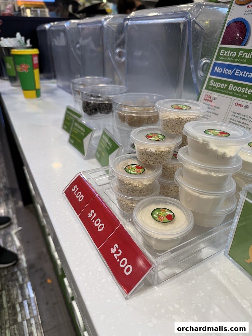 A display of ingredients and protein balls at Boost Juice with price tags.
