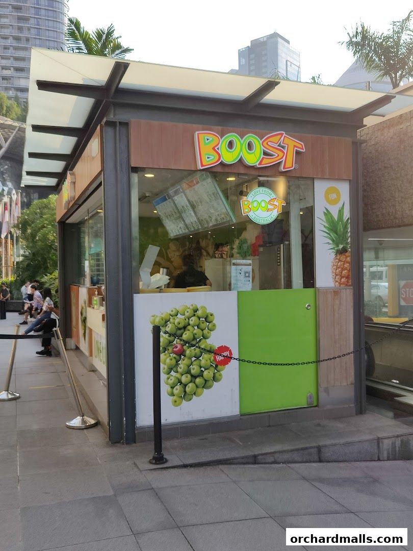 The exterior of a Boost Juice shop with its signature colorful branding and fruit imagery.