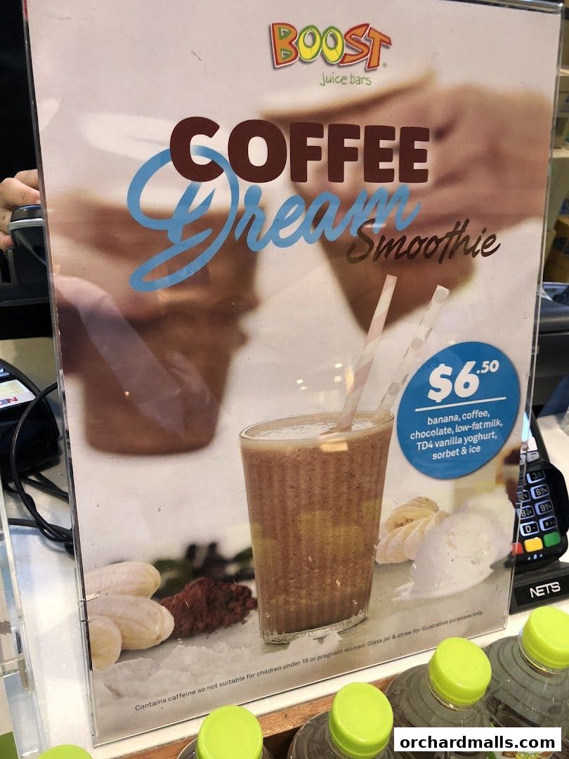 A menu board advertising the Boost Juice 'Coffee Dream Smoothie' with ingredients and price.