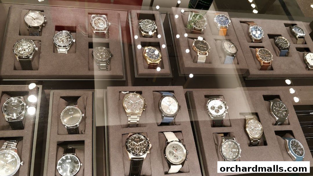 A display case filled with various BOSS brand watches, showcasing different styles and designs.