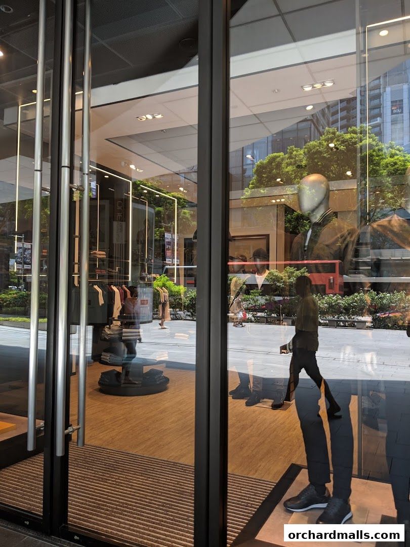 The entrance of a BOSS store with mannequins and clothing displays visible through the glass.