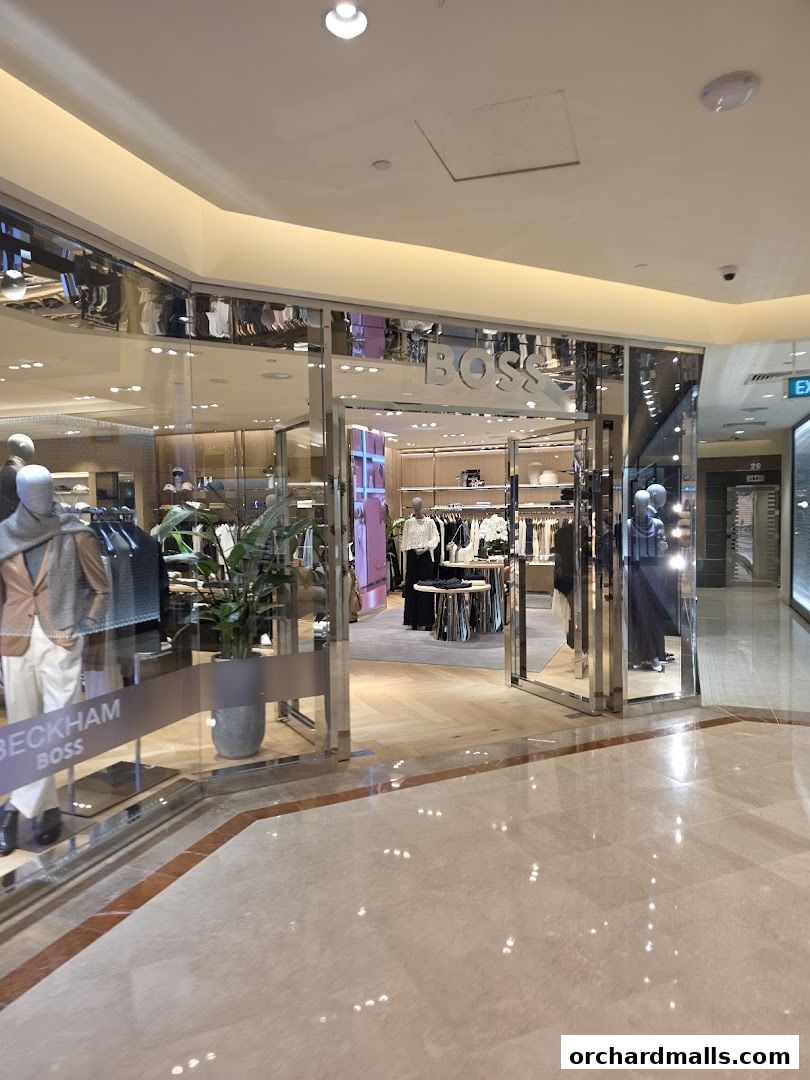 The entrance of a BOSS store showcasing men's fashion and accessories.