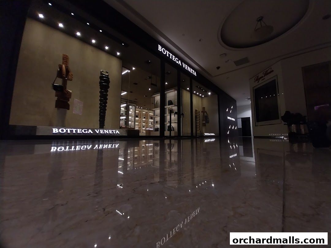 The elegant storefront of Bottega Veneta Singapore Takashimaya, showcasing luxury goods.