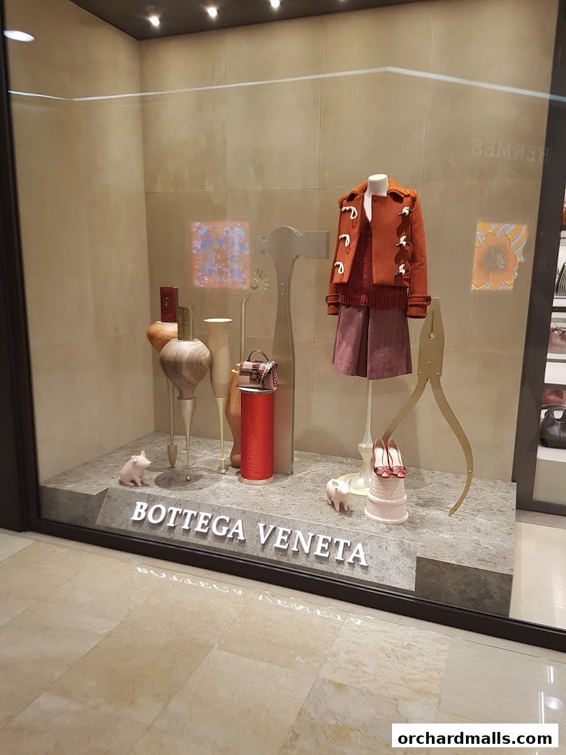 Bottega Veneta Singapore Takashimaya window display featuring autumn fashion and accessories.