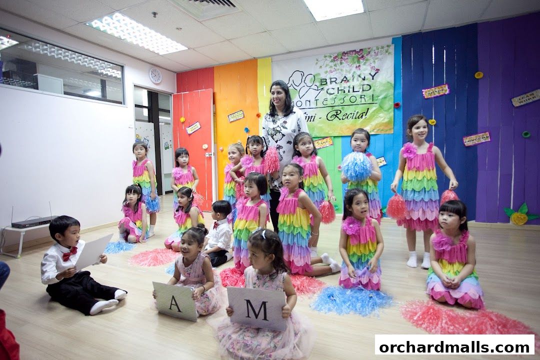 Children in colorful dresses perform at Brainy Child Montessori Learning Centre's mini-recital.