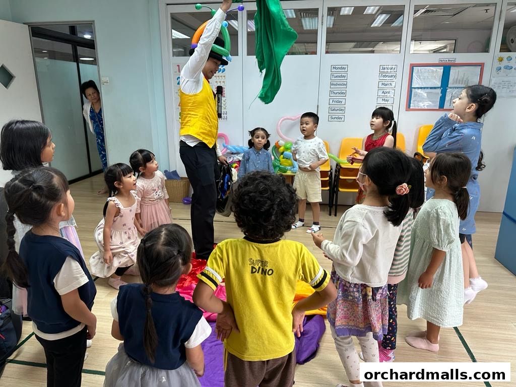 A magician entertains children at a Montessori learning center with a colorful performance.