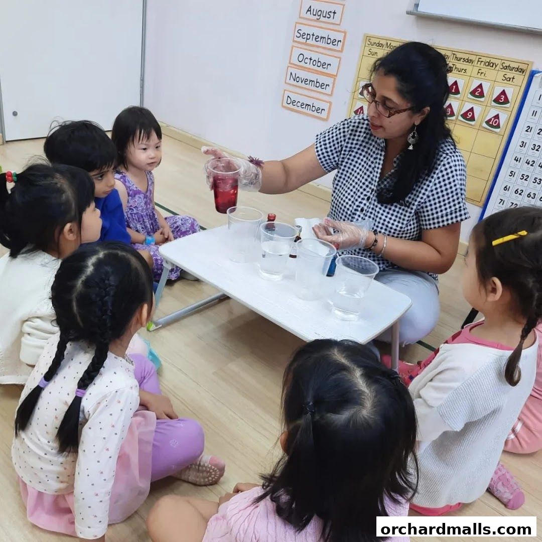 A teacher conducts a science experiment with young children in a classroom.