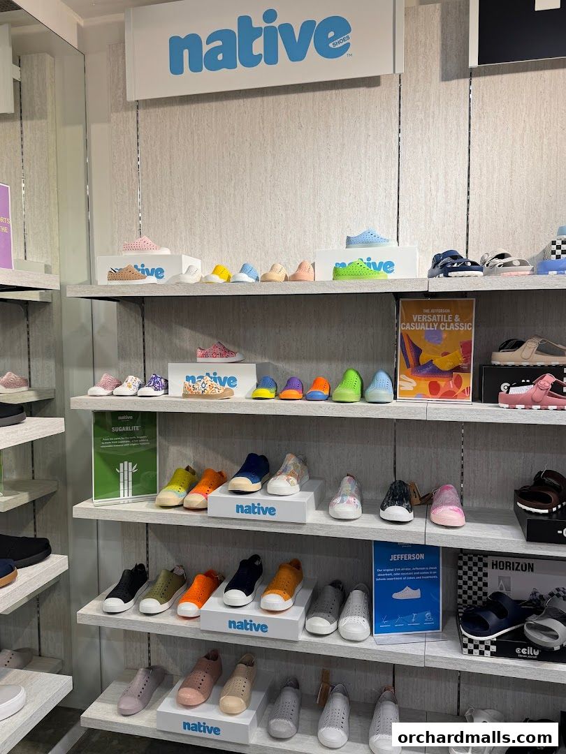 Shelves display a variety of colorful Native Shoes for adults and children.