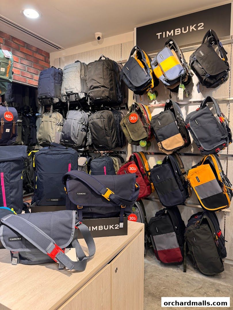 A wide selection of Timbuk2 backpacks and messenger bags displayed on shelves and walls.