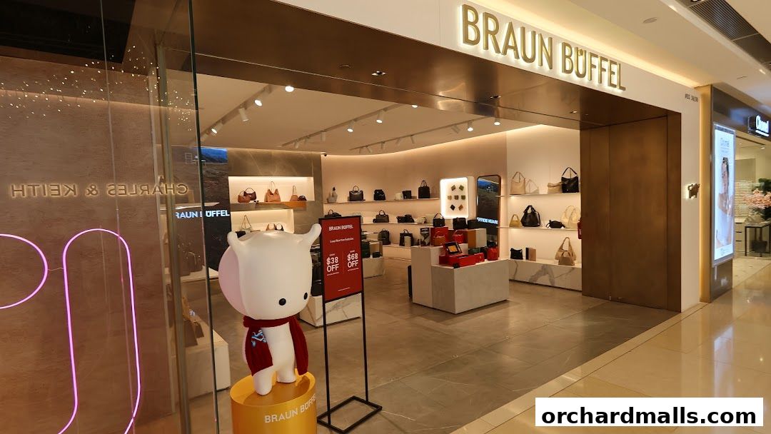 The entrance of a Braun Büffel store showcasing handbags and a promotional display.
