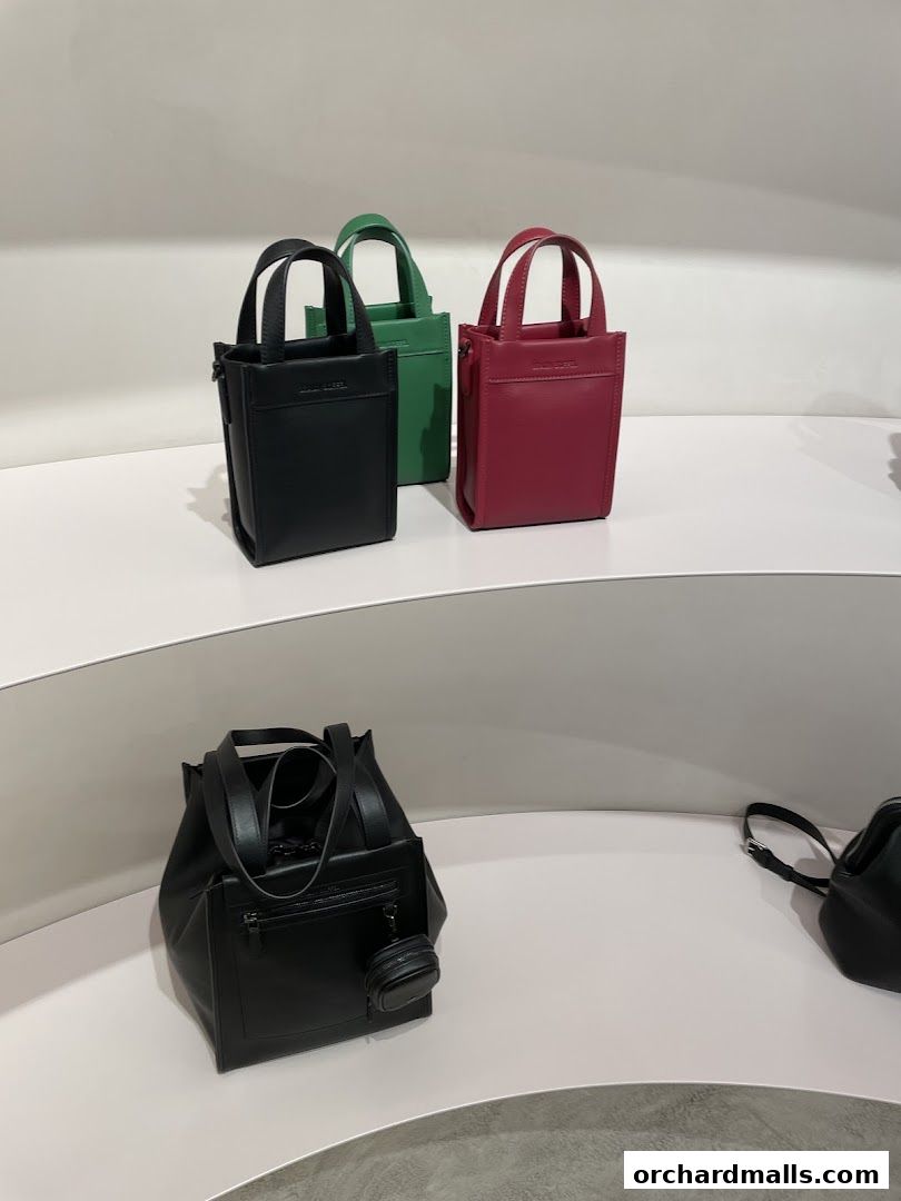 A display of stylish Braun Büffel handbags in various colors and sizes.