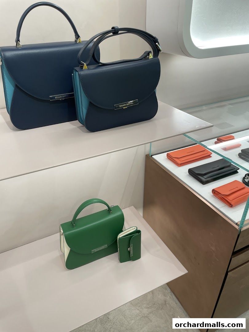 A display of stylish Braun Büffel handbags and wallets in various colors.
