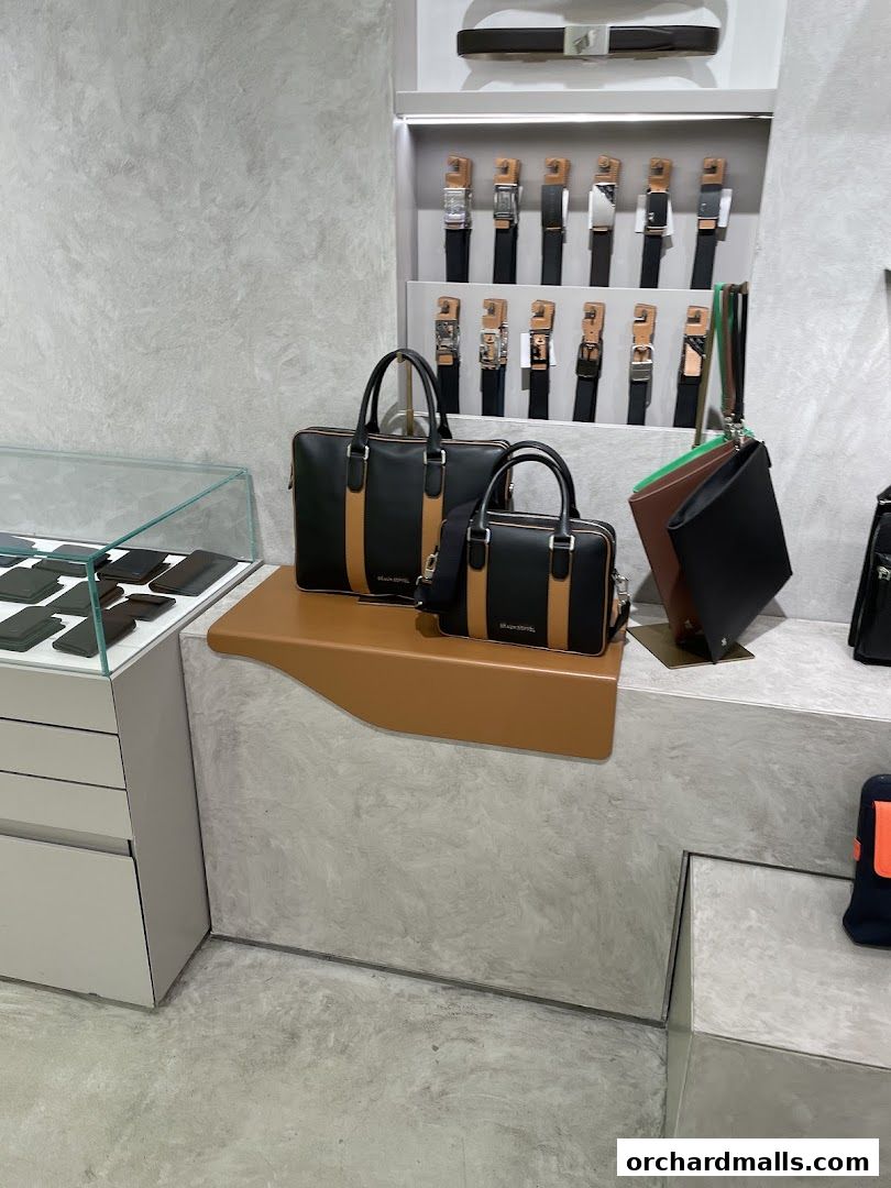 Stylish display of Braun Büffel bags and belts in a modern retail setting.