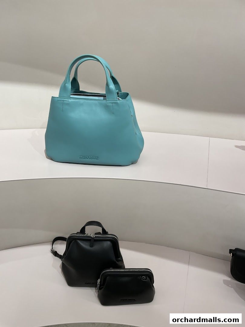 A display of stylish Braun Büffel handbags in various colors and sizes.