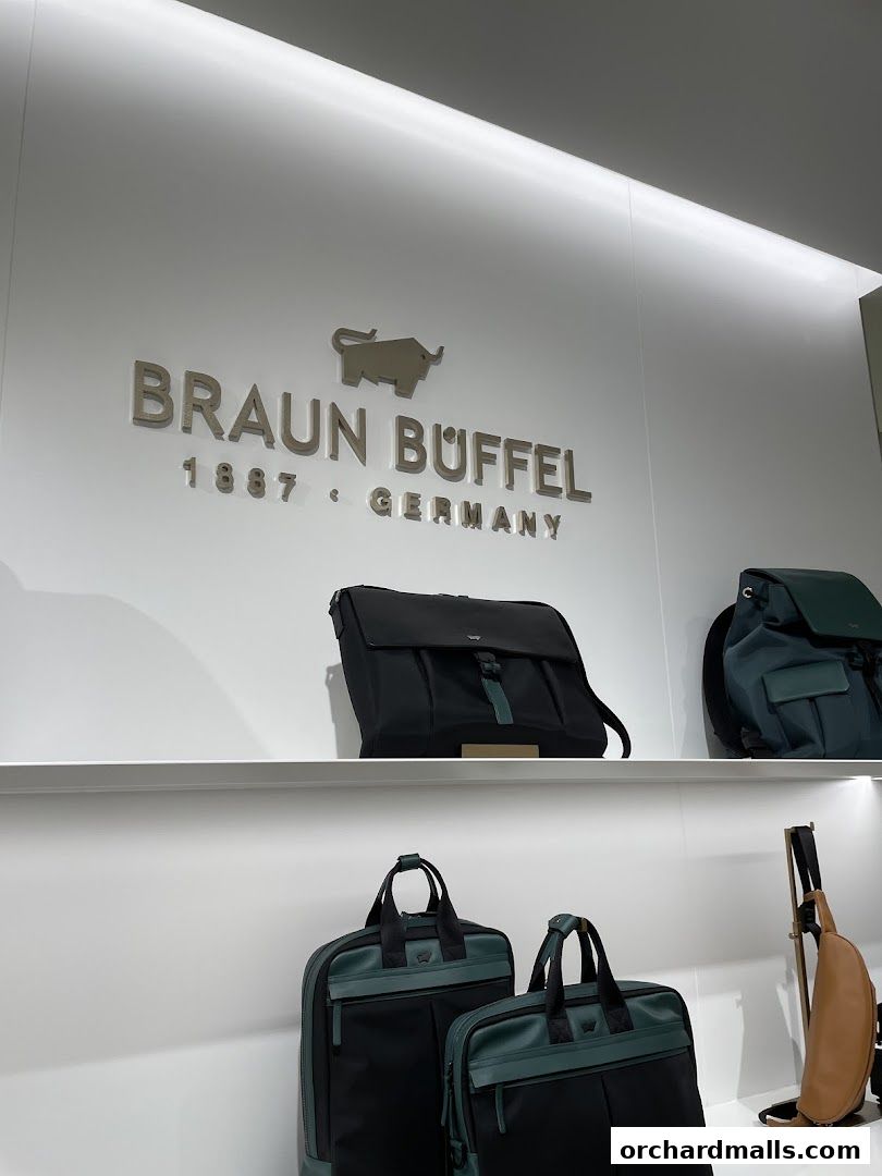 Braun Büffel store interior showcasing stylish bags and the brand's logo.