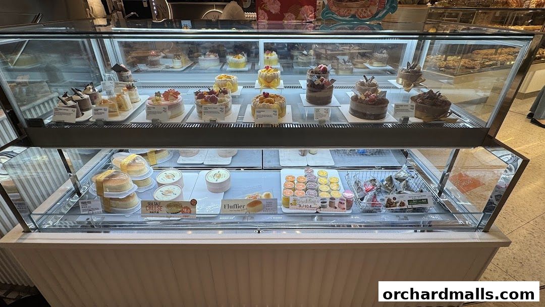 A display case filled with various cakes, pastries, and desserts from BreadTalk.