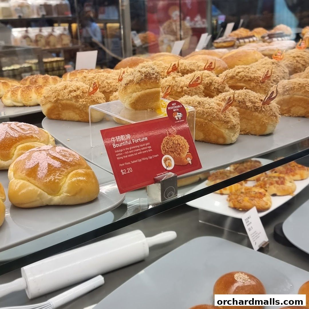 A display of freshly baked bread rolls with various toppings and fillings at BreadTalk.