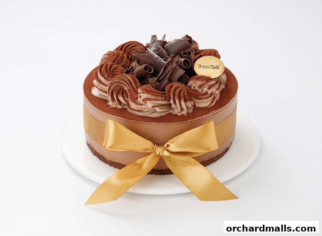 A decadent chocolate cake from BreadTalk, adorned with swirls of frosting and chocolate shavings.