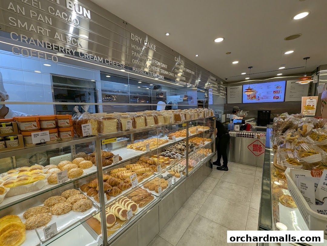 Interior view of a BreadTalk bakery showcasing a wide variety of fresh bread, pastries, and cakes on display.