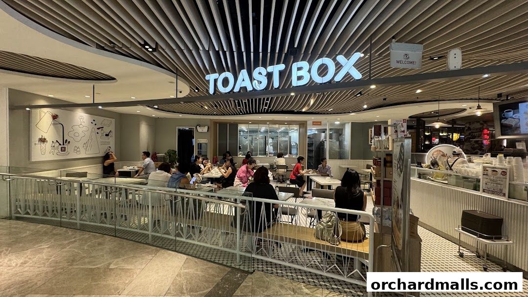 Interior view of Toast Box with customers dining and staff behind the counter.