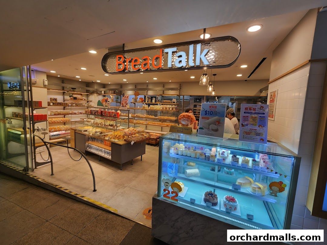 The exterior of a BreadTalk bakery, showcasing a display of cakes and pastries.
