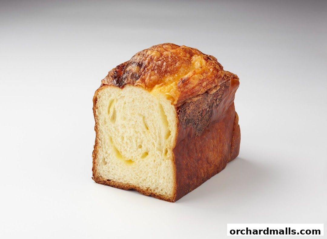 A loaf of bread with a golden-brown crust and a soft, airy interior.