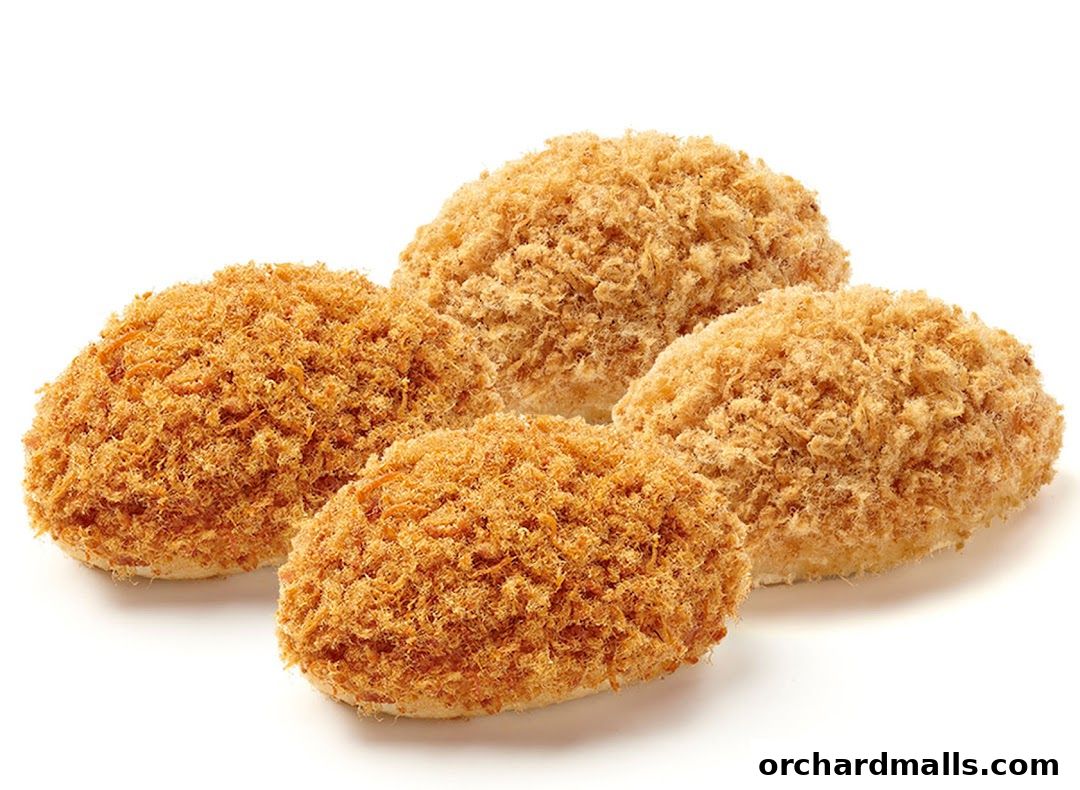 Four fluffy bread rolls topped with savory shredded pork floss.