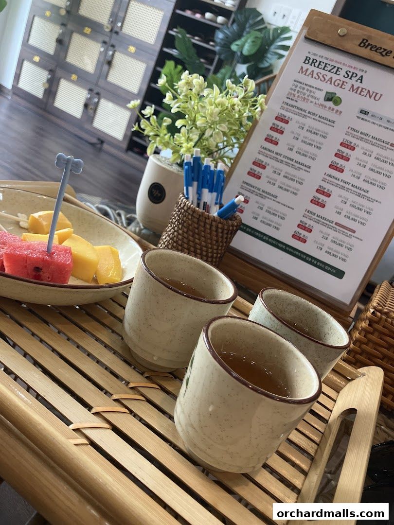 A spa menu with massage services, tea, and fruit displayed.