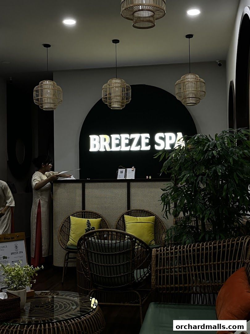 The reception area of Breeze Spa features a lit sign, seating, and decorative lighting.