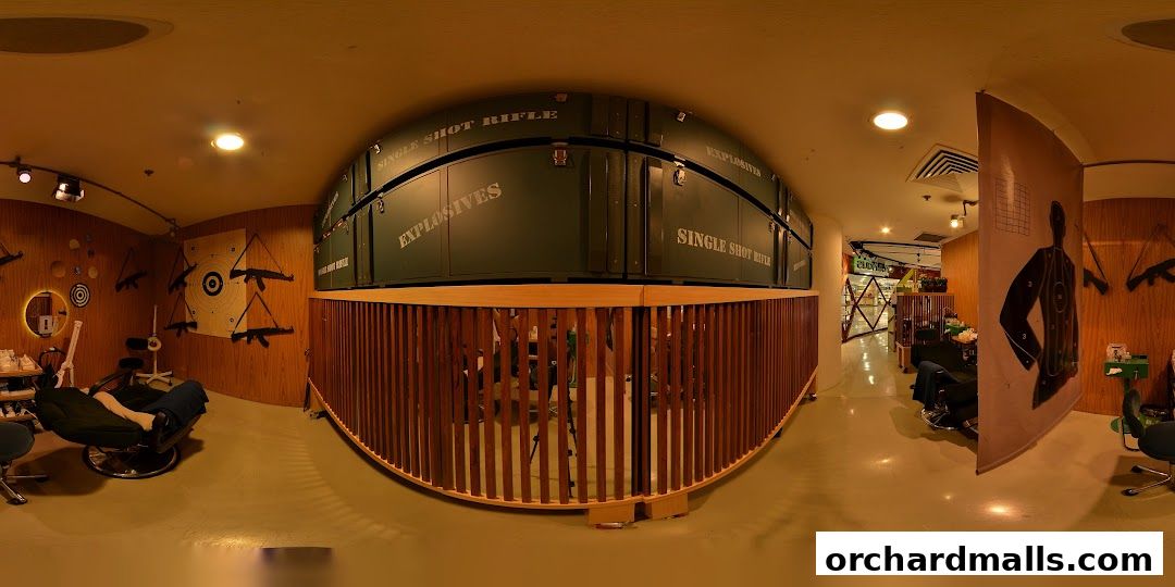 Interior of a shop with targets, rifles, and seating areas.