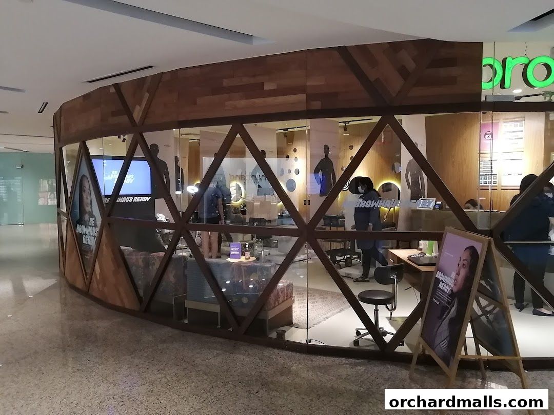 Browhaus Wheelock shop interior with staff and promotional displays visible through glass.