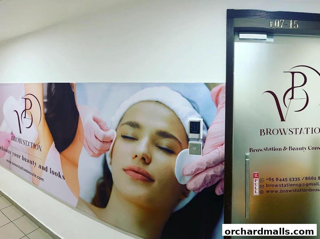 The entrance of Browstation Beaute, a beauty salon, with a large banner and frosted glass door.