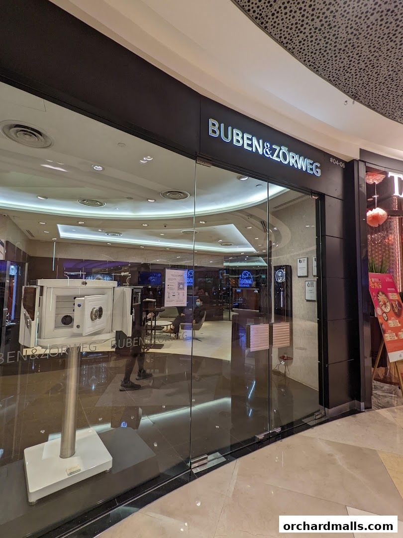 The modern storefront of Buben & Zorweg SG, featuring a glass facade and illuminated signage.