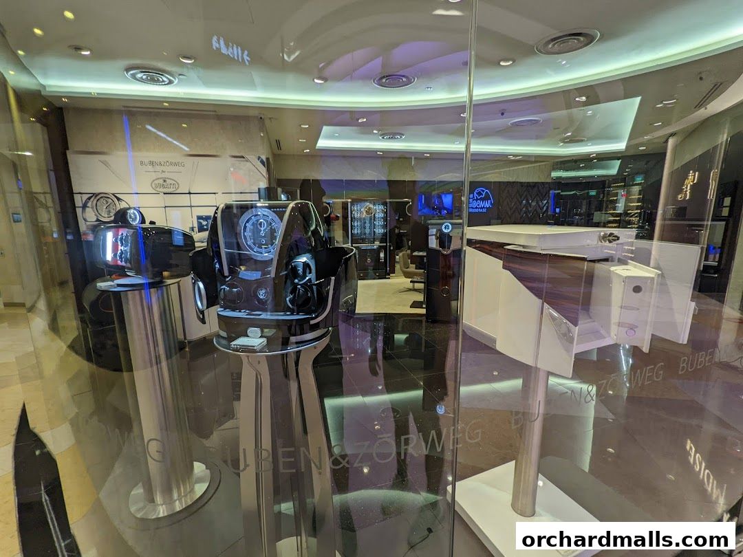 Interior view of a luxury watch and accessory store, Buben & Zorweg, showcasing display cases and products.