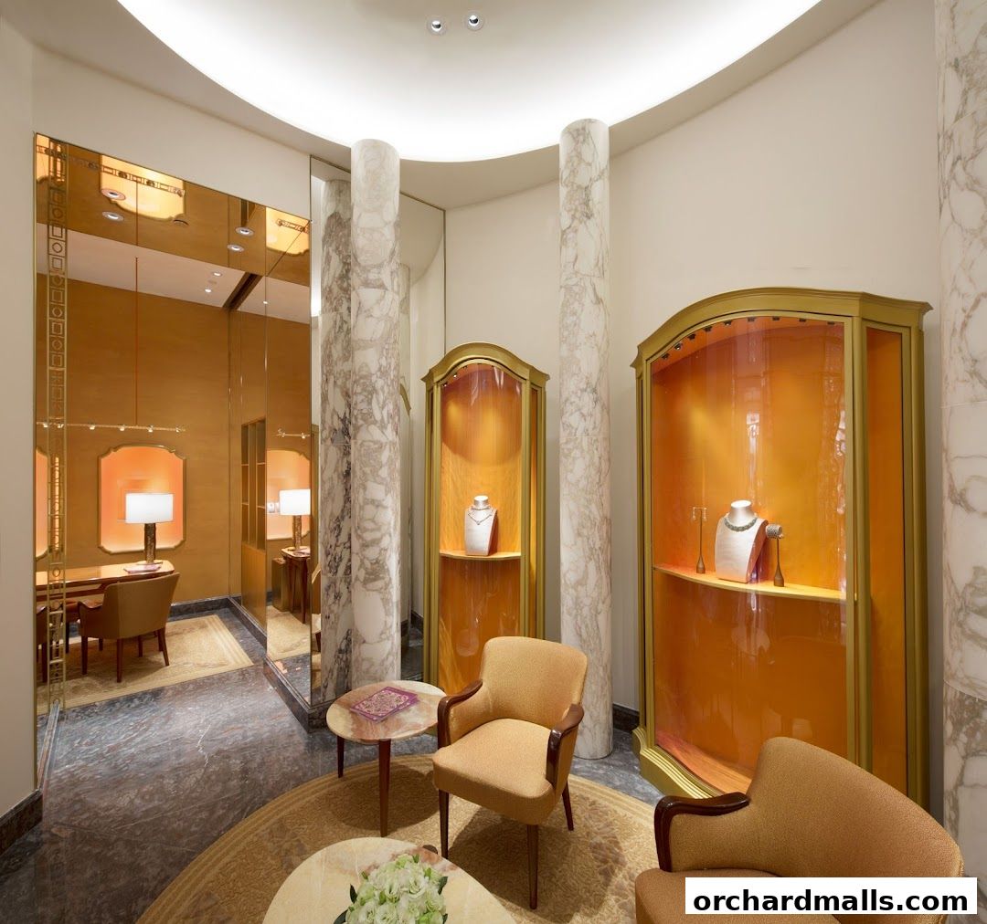 Interior view of a luxurious jewelry store with display cases and seating.
