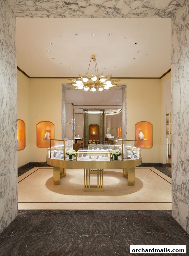 Interior of a luxurious jewelry store with display cases and a chandelier.