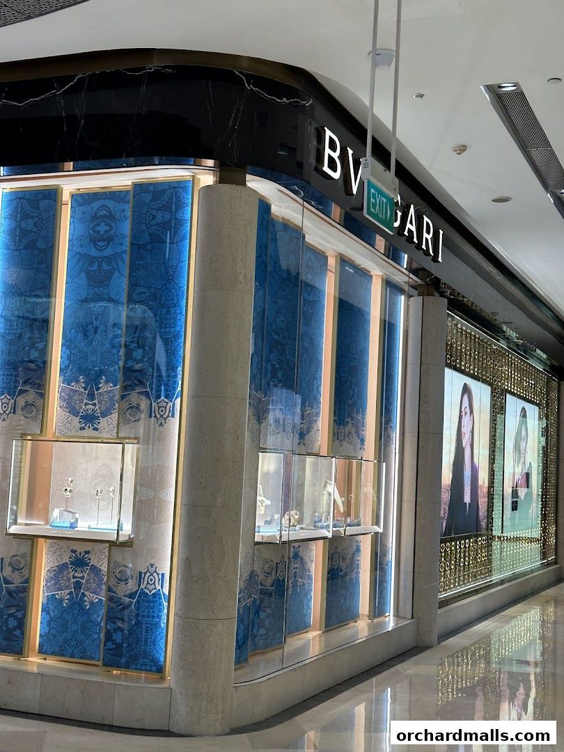 The exterior of a luxury jewelry store with illuminated displays and elegant signage.