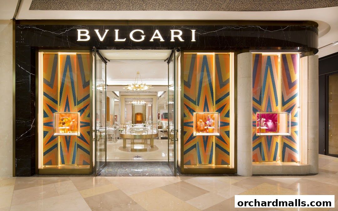 The exterior of a Bulgari store with illuminated display windows showcasing jewelry.
