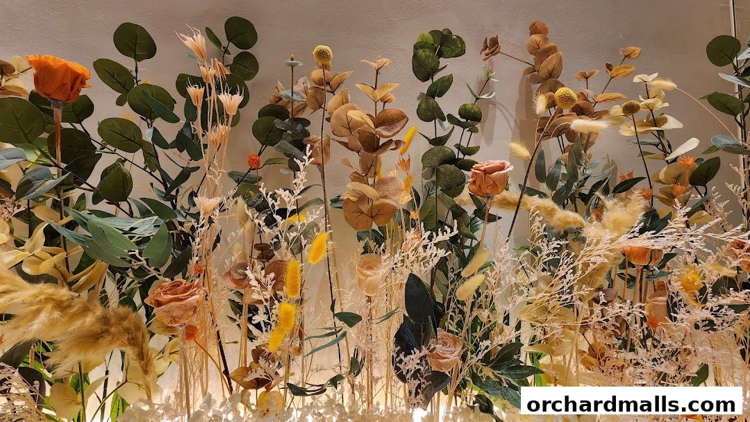 A beautiful arrangement of dried flowers and eucalyptus leaves in warm, earthy tones.