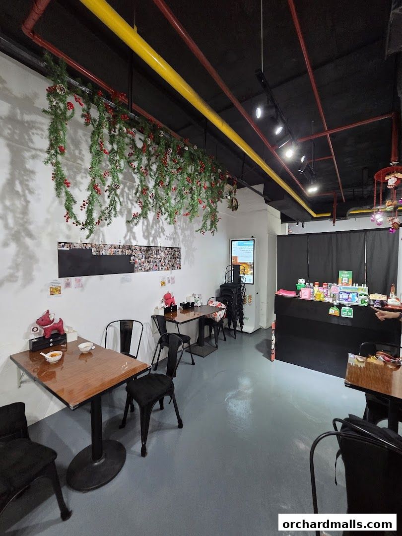 Interior of Cafe Blossom with tables, chairs, and festive decorations.