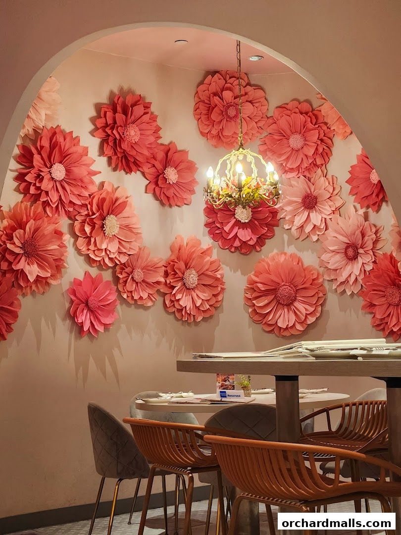 A cafe interior with floral wall decorations and a chandelier.